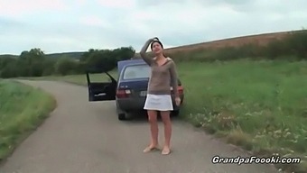 Young Girl Entices Grandpa In Outdoor Setting